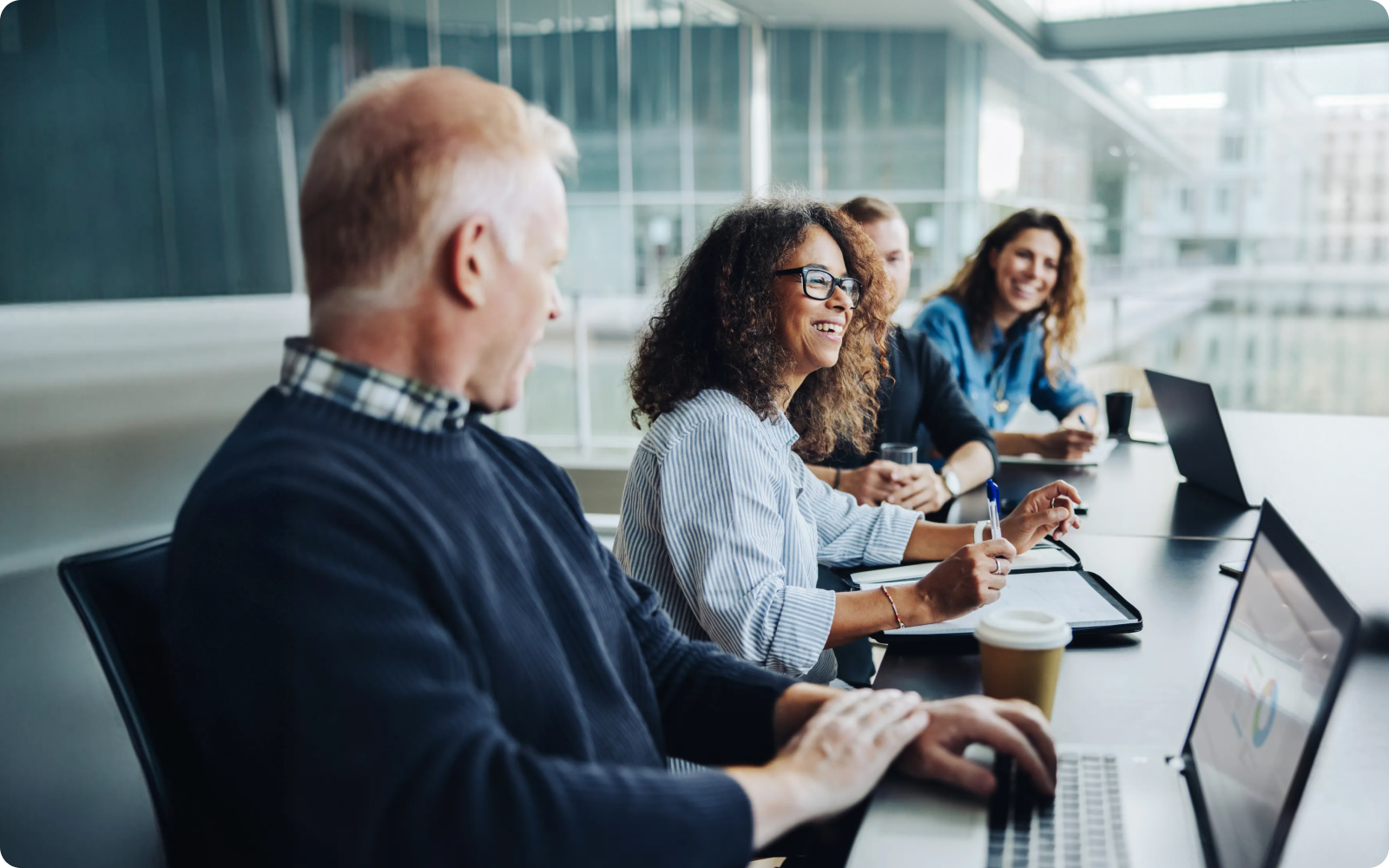 Group of office workers at a desk working on their real estate agent website checklist