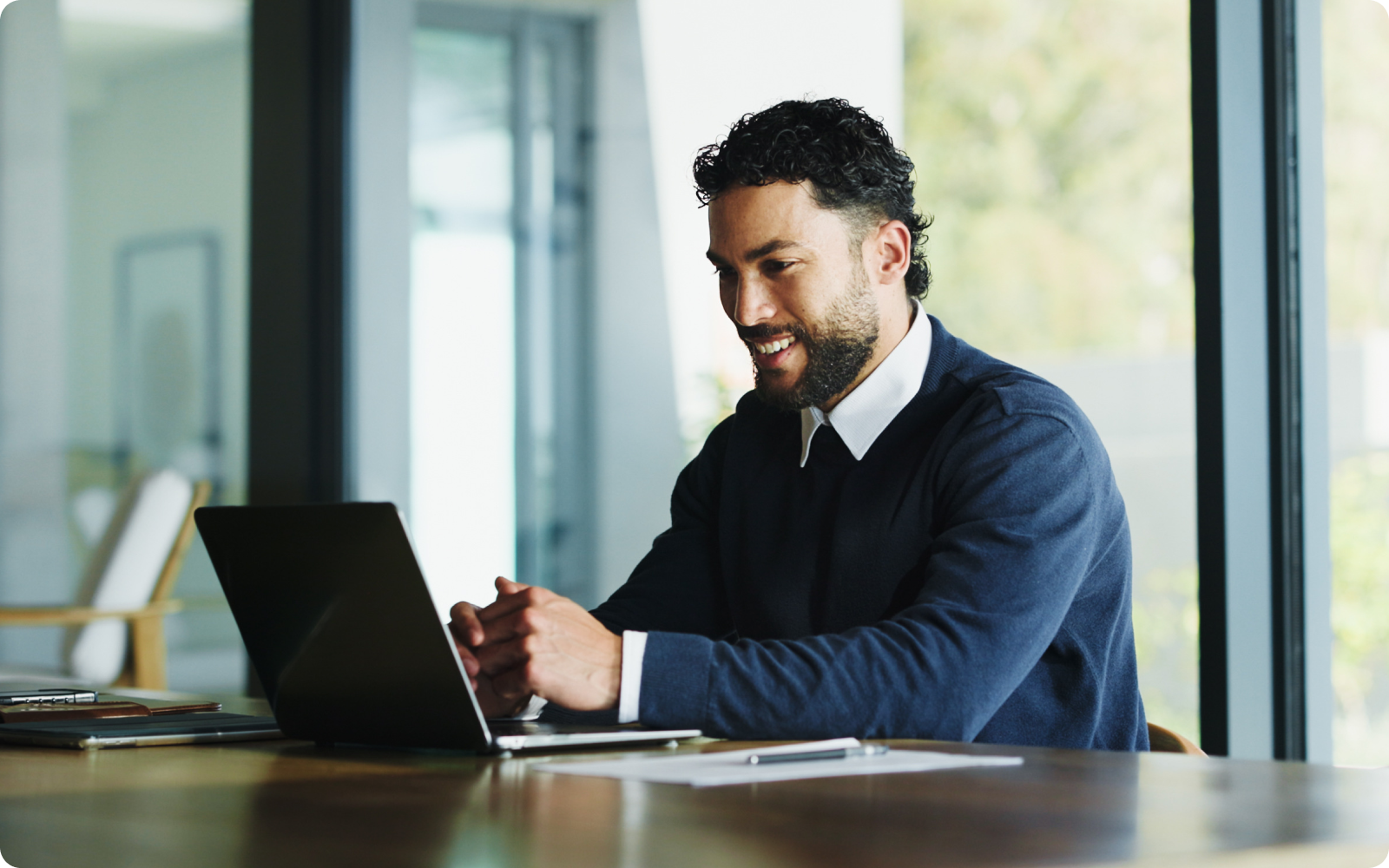 A man look at his laptop putting together his real estate agent website checklist