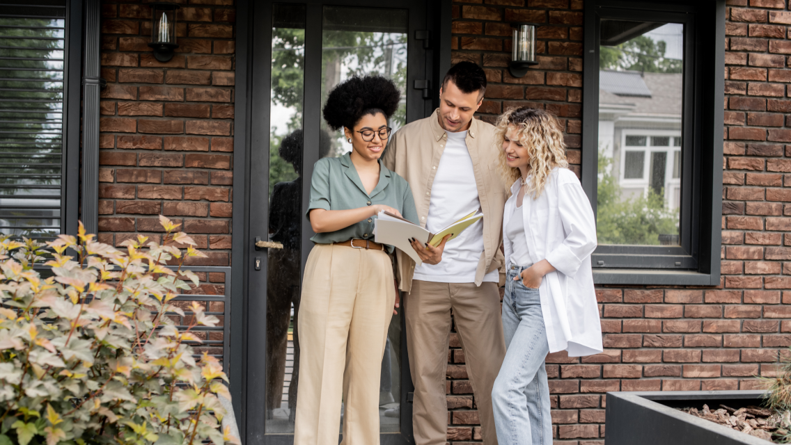 agent and couple reviewing paperwork for buyer agent transaction checklist blog
