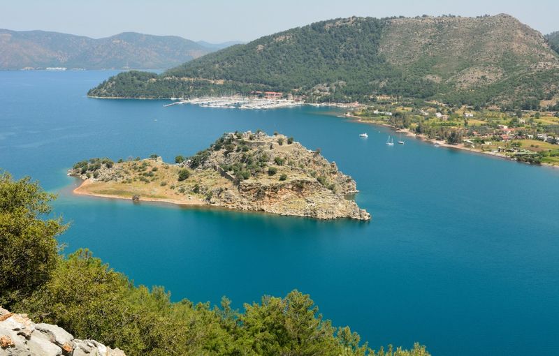 Orhaniye bay, fortified islet and Orhaniye village on Bozburun peninsula in Turkey.