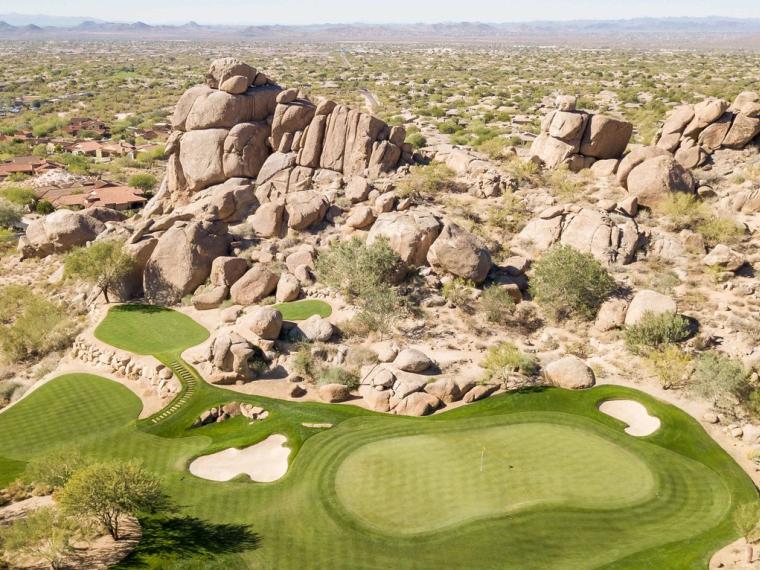Granite boulder outcrops rising beside the desert course at Whisper Rock