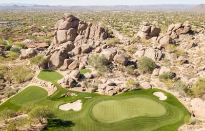 Granite boulder outcrops rising beside the desert course at Whisper Rock