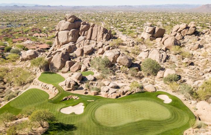 Granite boulder outcrops rising beside the desert course at Whisper Rock
