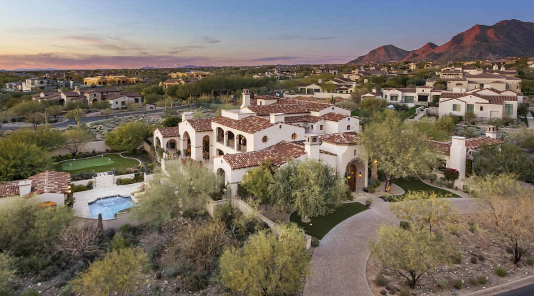 Tile-roofed Andalusian homes in Silverleaf at dusk, the McDowell Mountains behind them