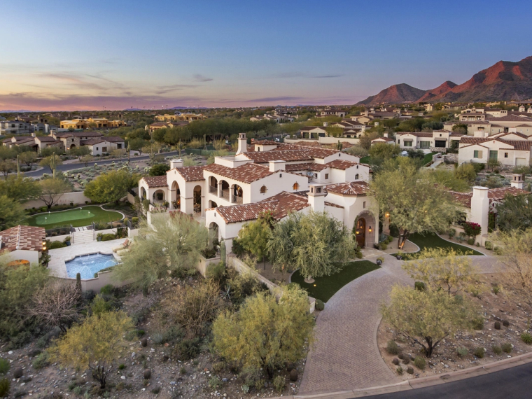 Tile-roofed Andalusian homes in Silverleaf at dusk, the McDowell Mountains behind them