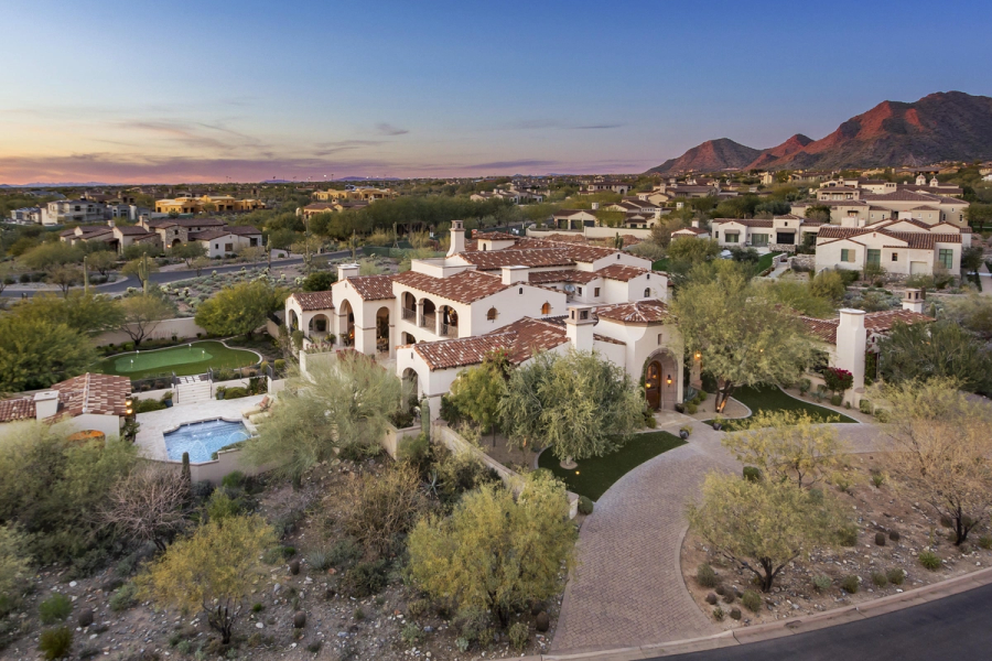 Tile-roofed Andalusian homes in Silverleaf at dusk, the McDowell Mountains behind them