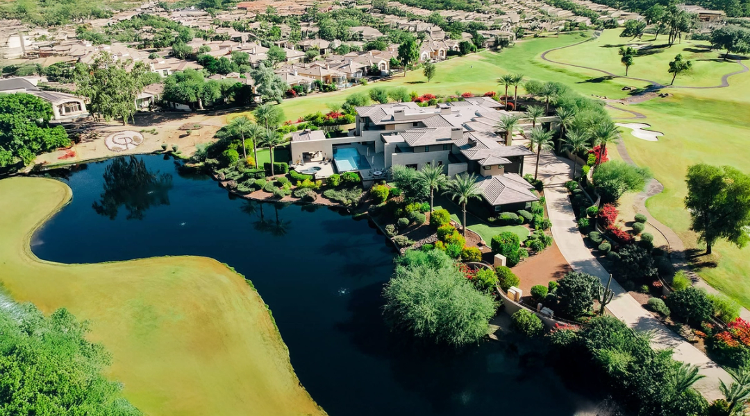 Aerial view of Gainey Ranch homes set among lakes, fairways and mature landscaping