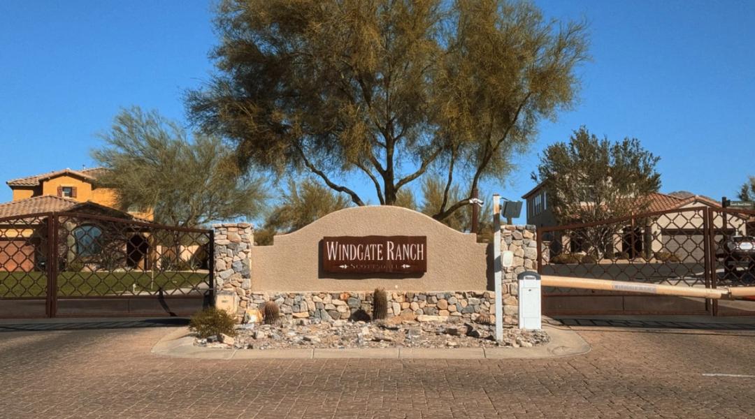 The stone entry monument at Windgate Ranch against the McDowell Mountains