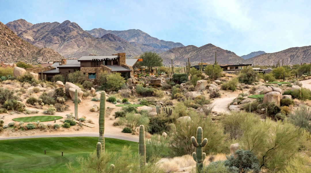 A single low desert-contemporary home set far back in open Sonoran desert, mountain ridge behind it