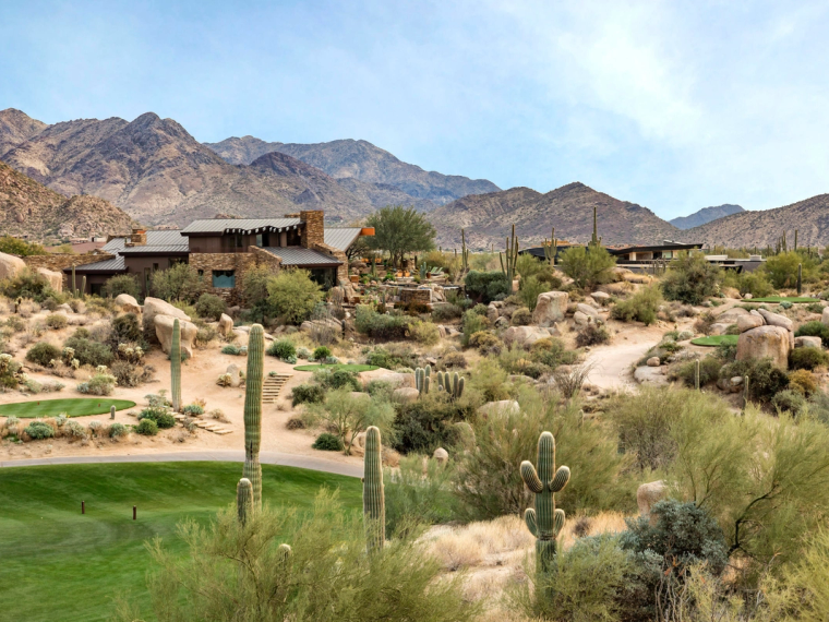 A single low desert-contemporary home set far back in open Sonoran desert, mountain ridge behind it