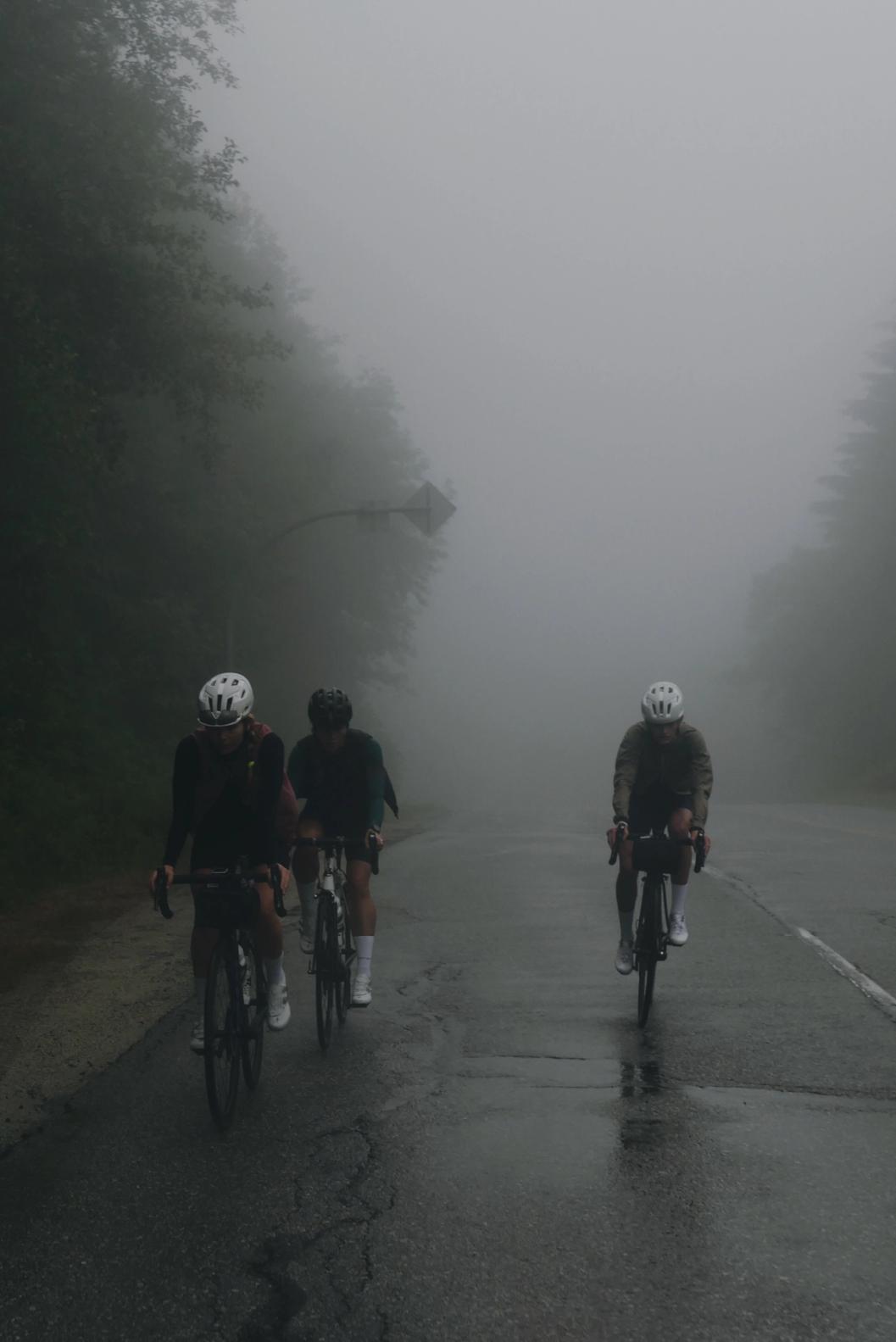 Three Enroute riders cycling into the clouds up cypress mountain in vancouver