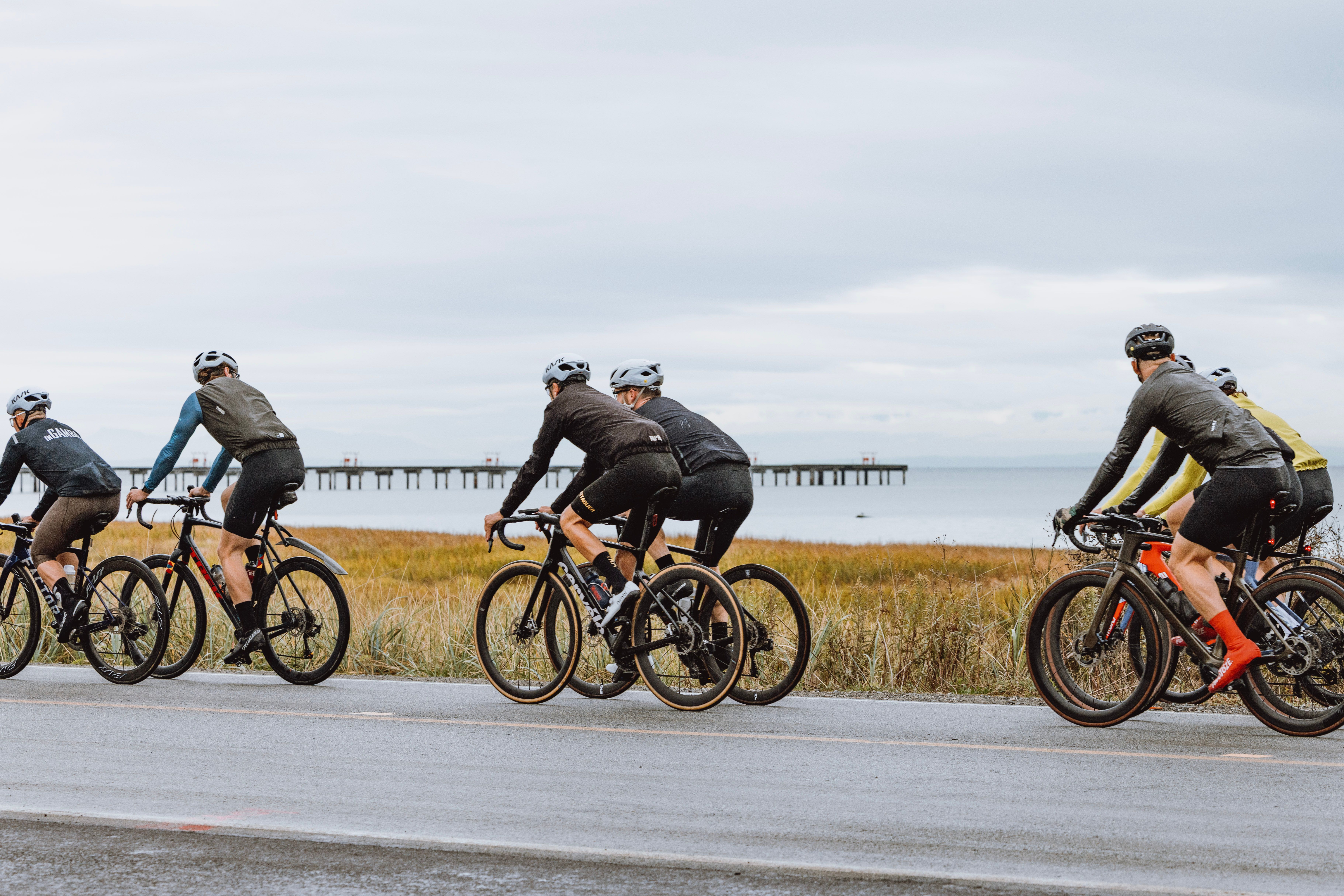 Cyclists in MAAP Apparel in front of water