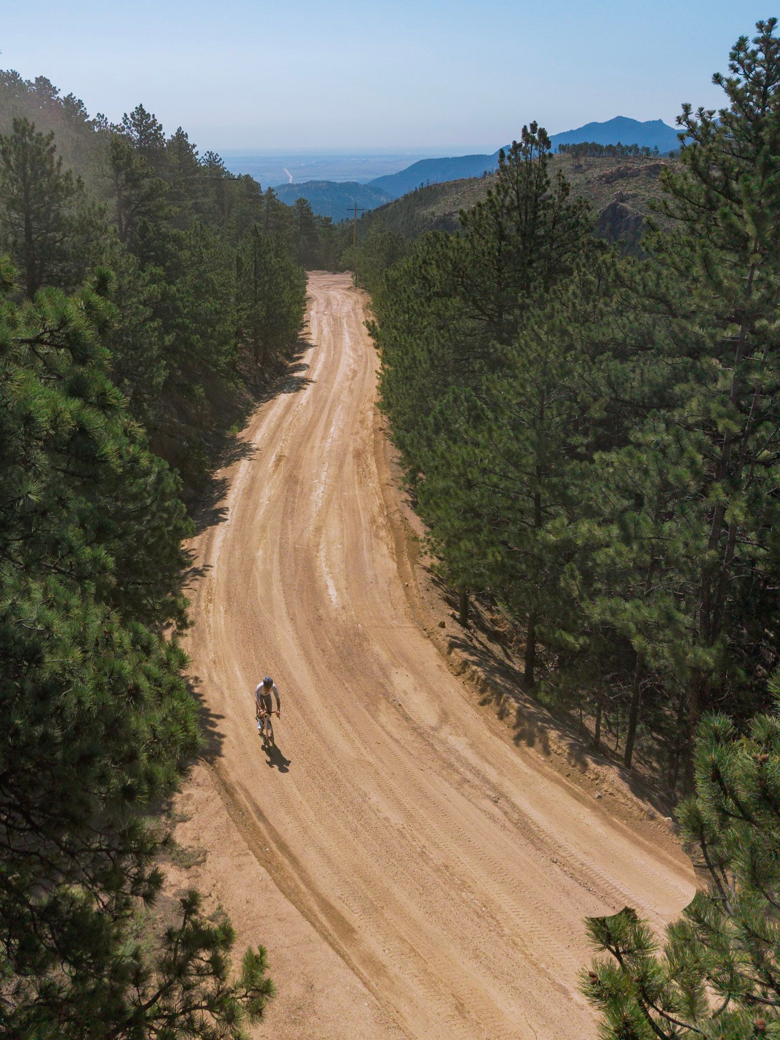 Aerial view of a dirt road climbing through the mountains above Boulder, Colorado