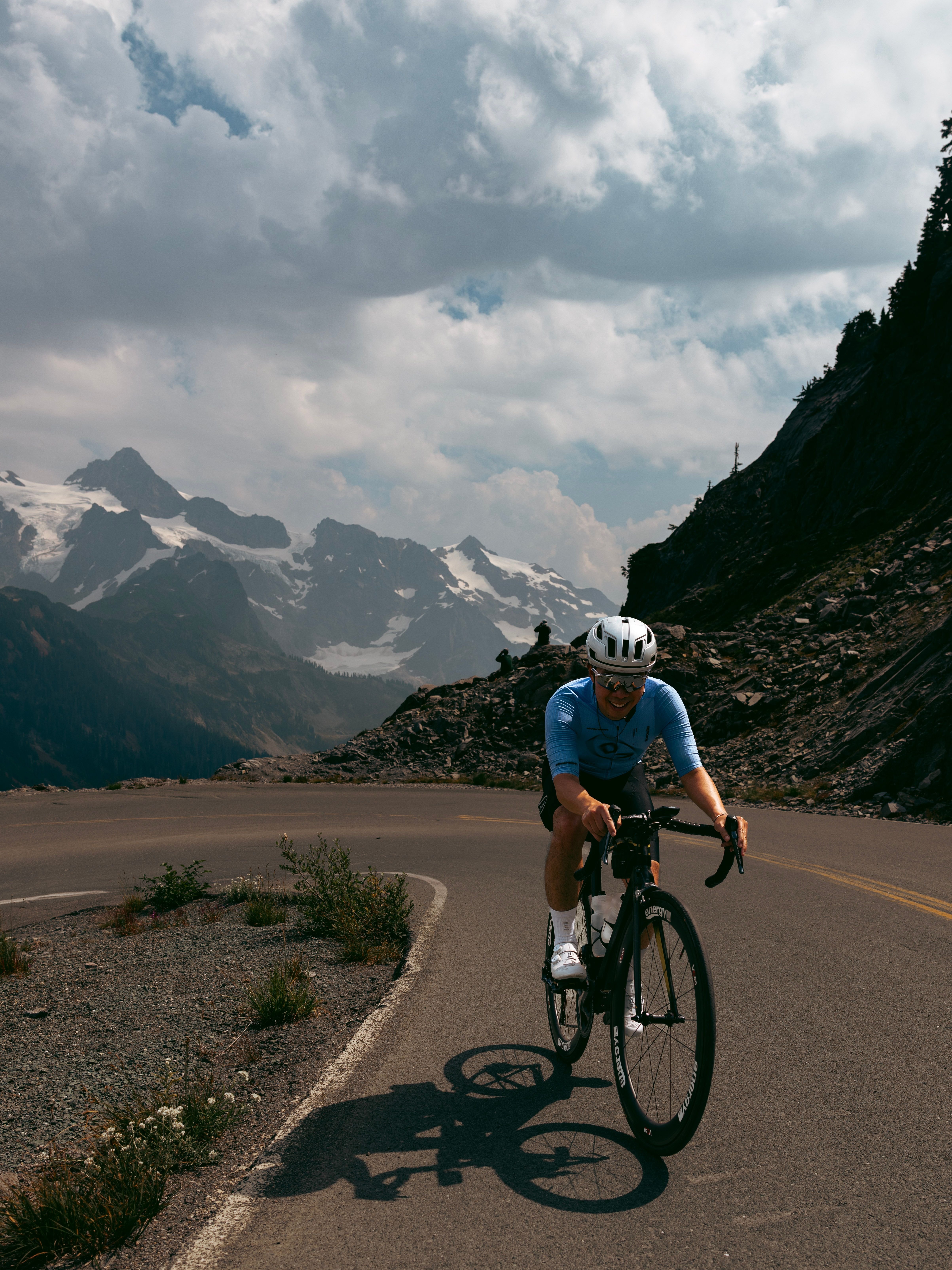 Cyclists wearing the Diversion Cycling Jersey in front of a mountain range