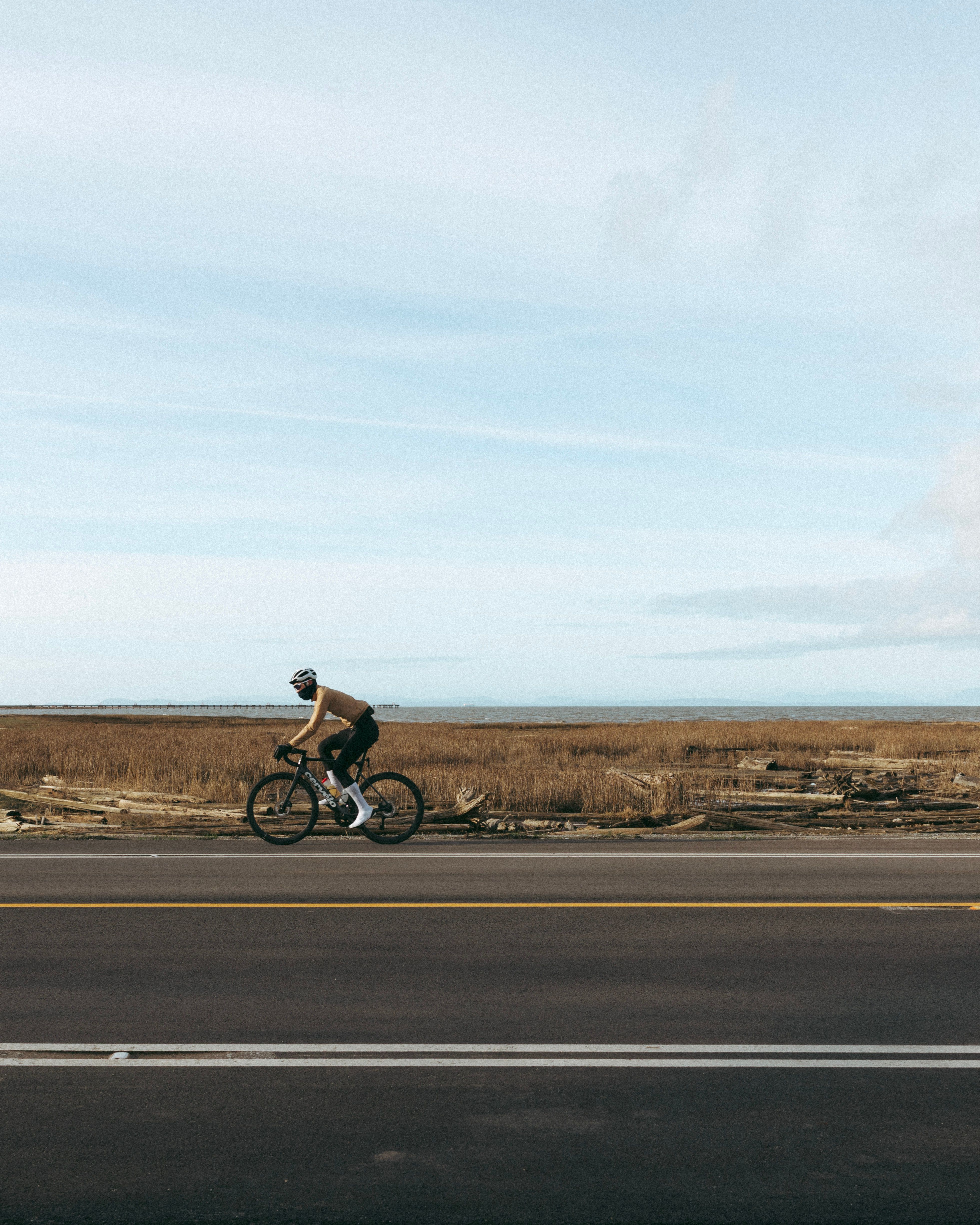 Cyclists riding in front of water
