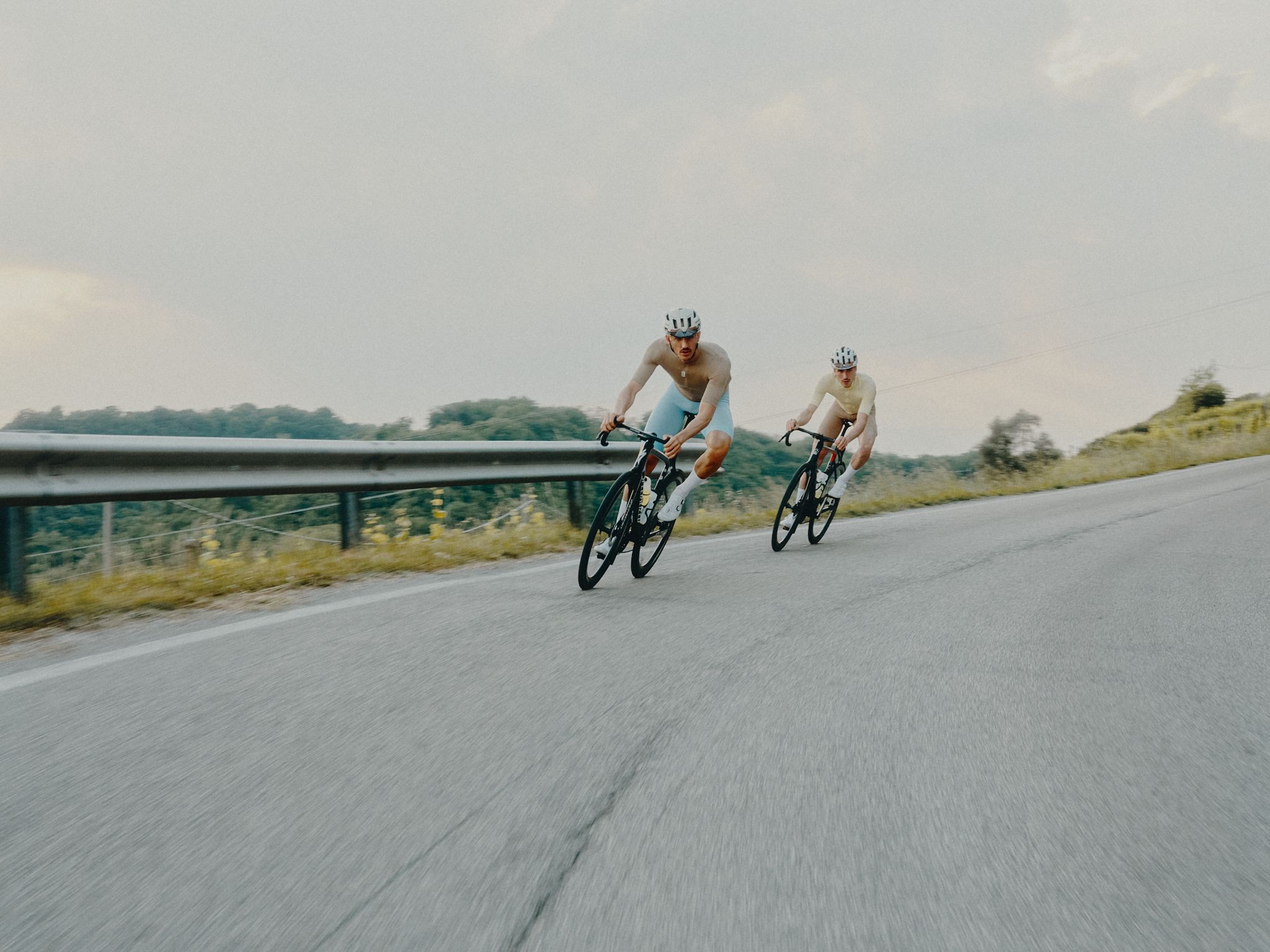 Cyclist riding coastal Mediterranean road