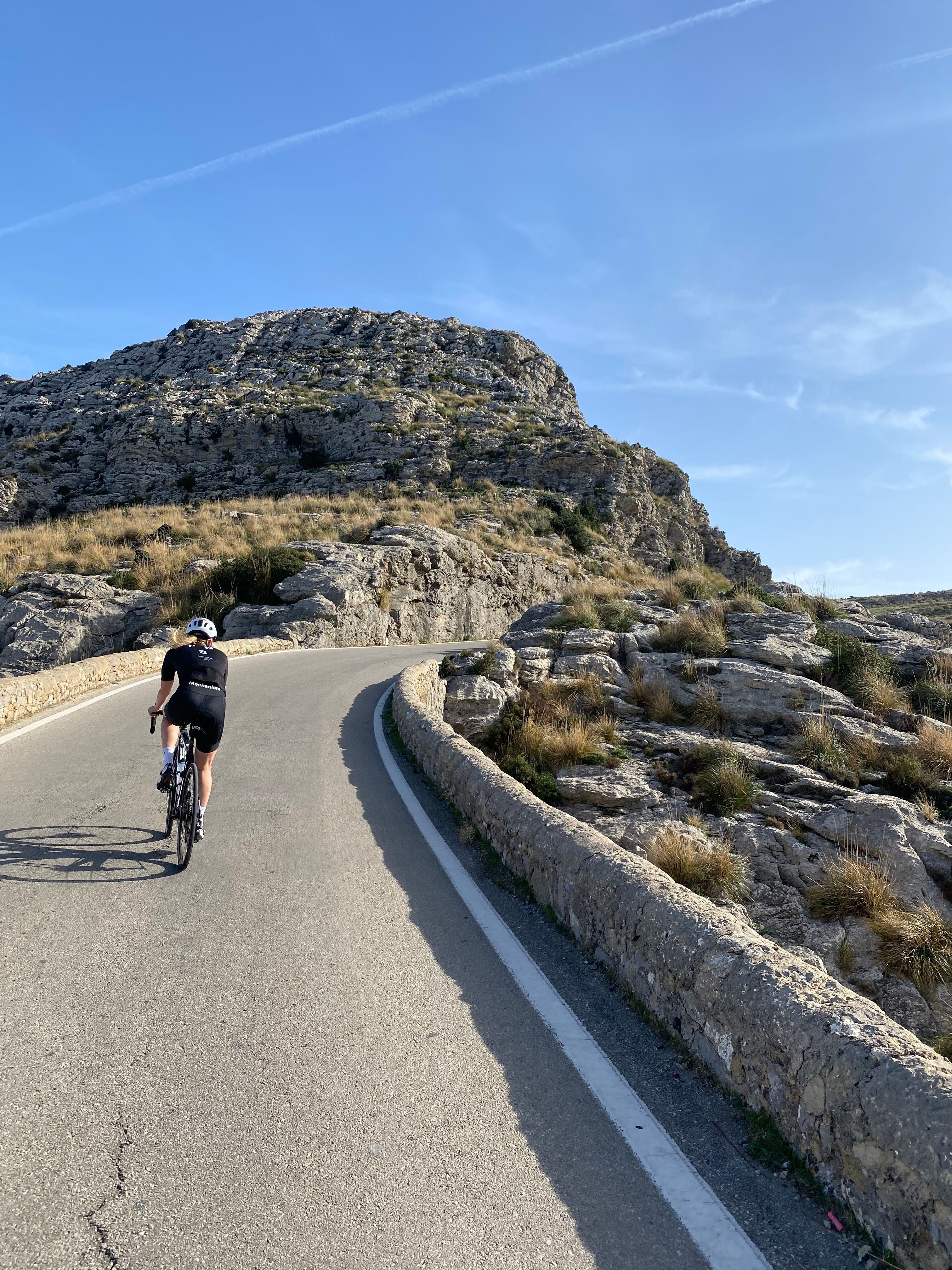 Cyclist riding in Mallorca in Pas Normal Studios kit