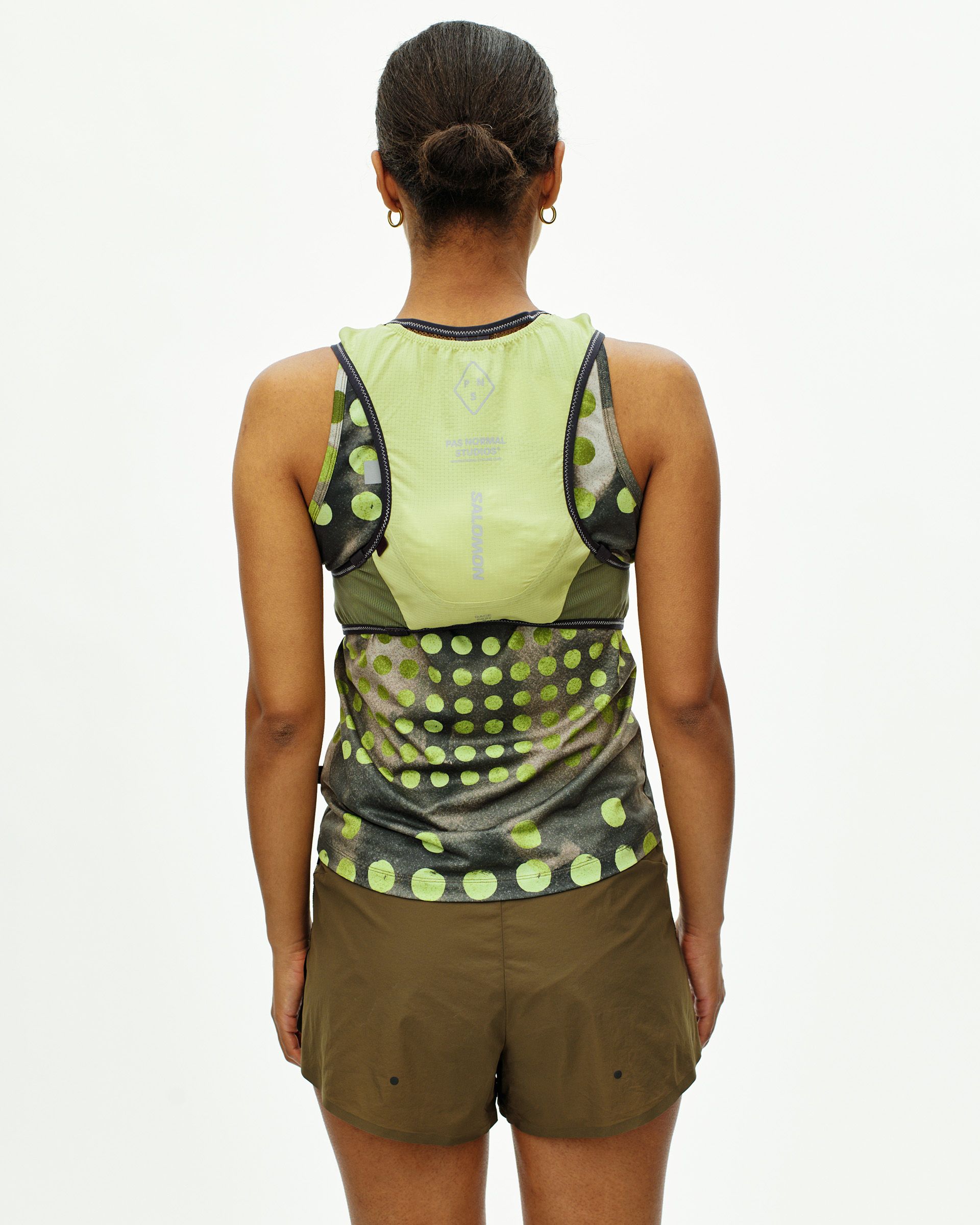 T.K.O. Race Skin 2 hydration vest back panel detail showing mesh ventilation and reflective Pas Normal Studios and Salomon branding