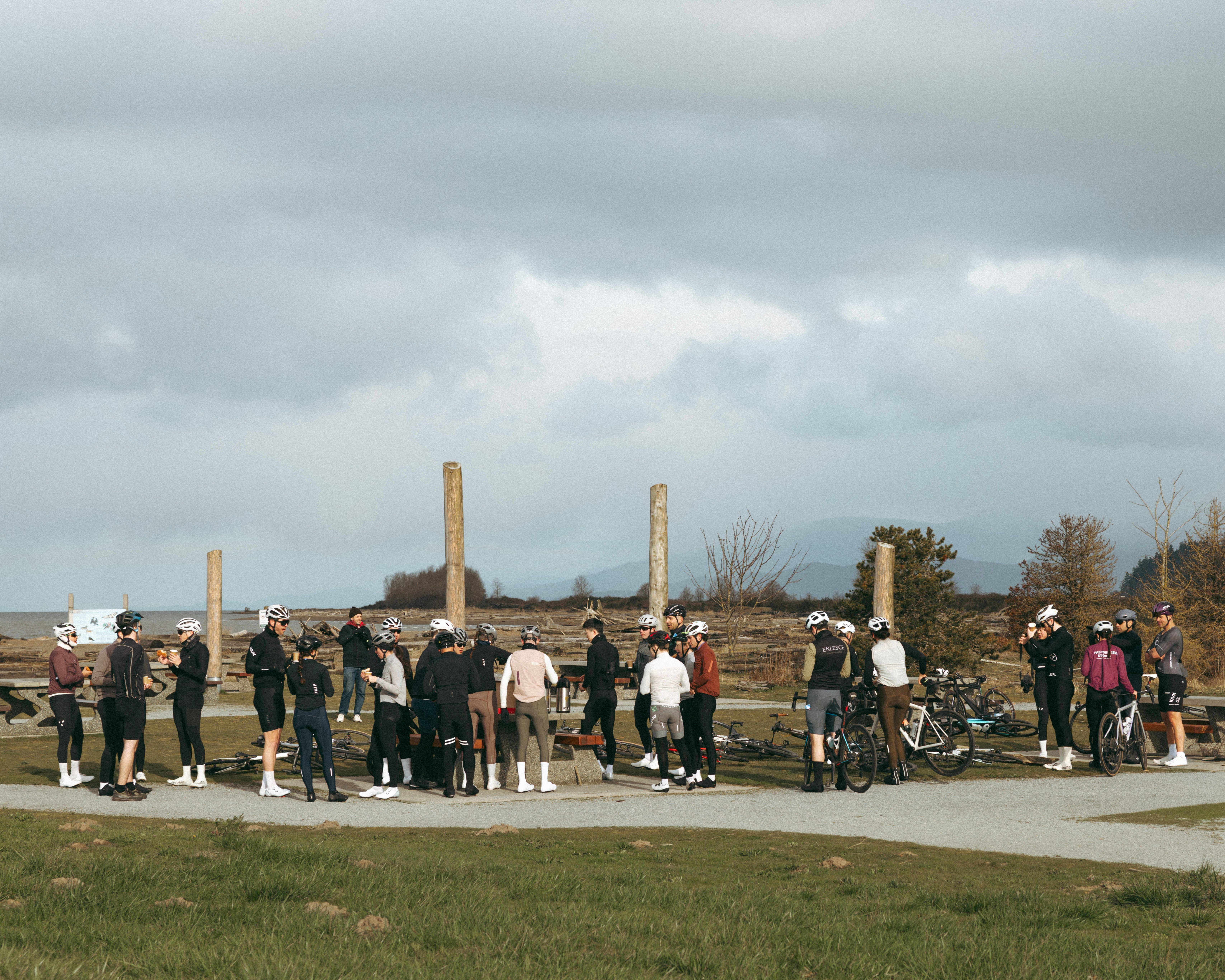 Cyclists standing in Iona Regional Park drinking coffee