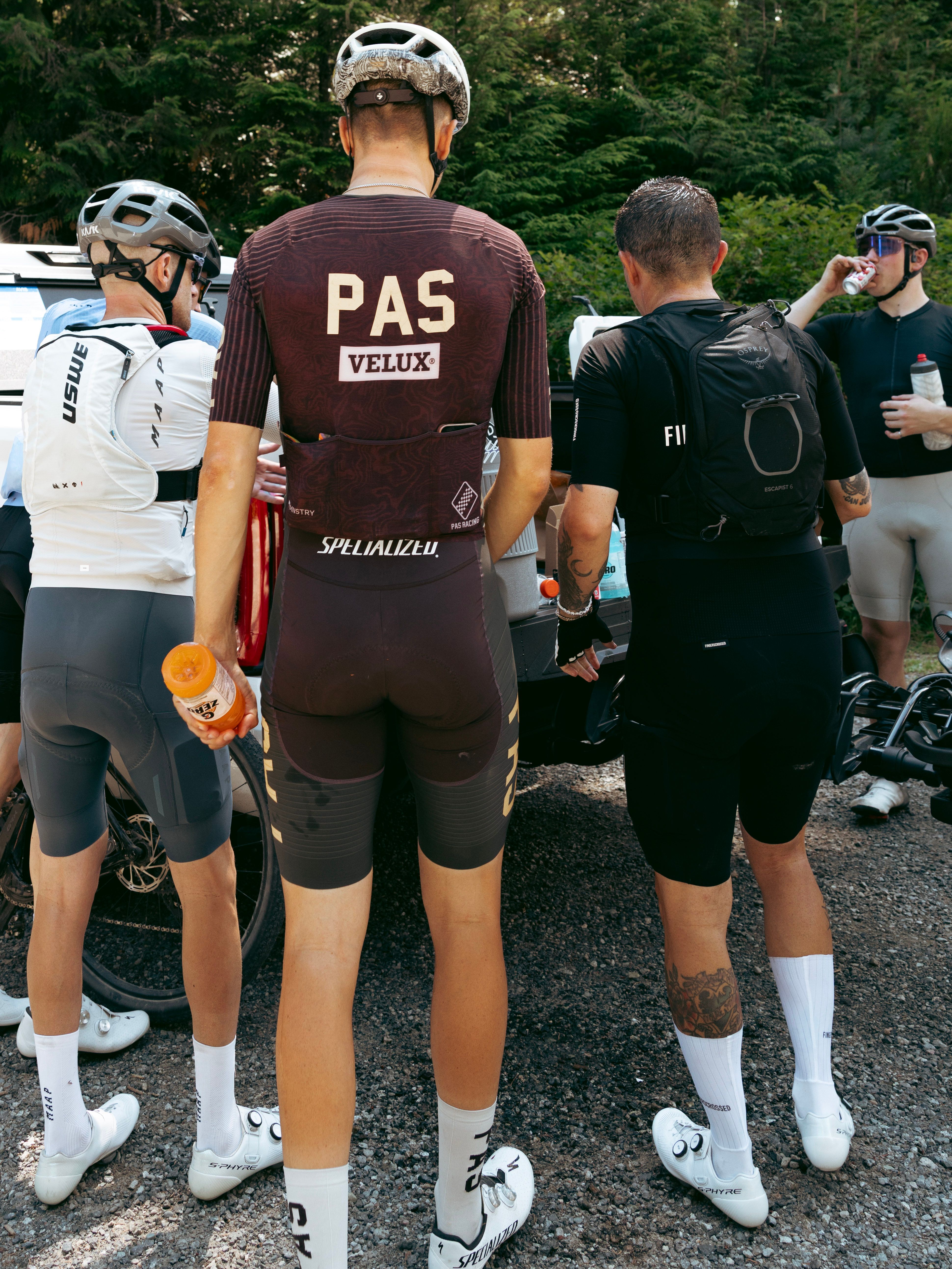 Cyclists in Pas Normal Studios in front of a truck