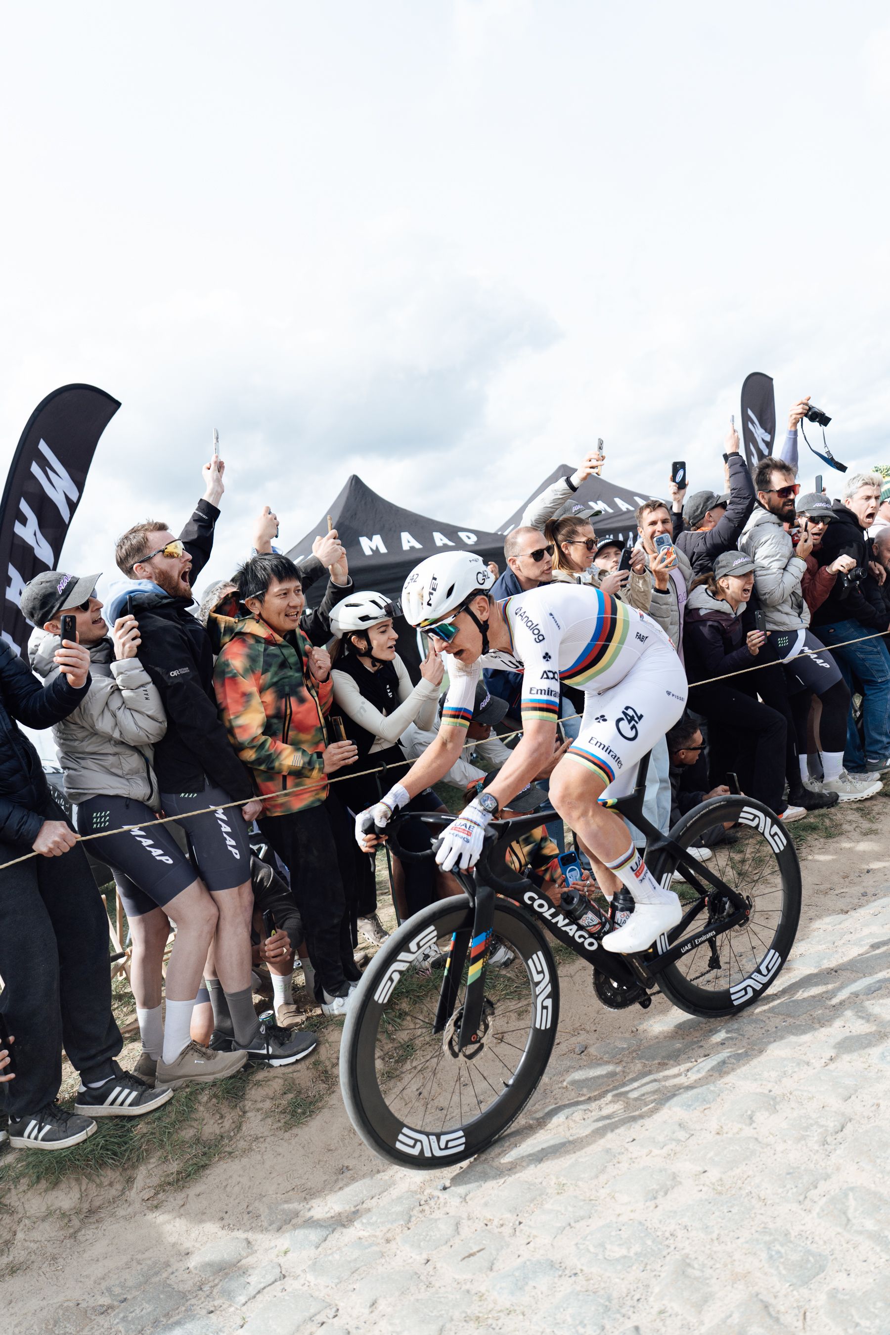 Tadej Pogacar riding in front of the MAAP tent at Paris Roubaix