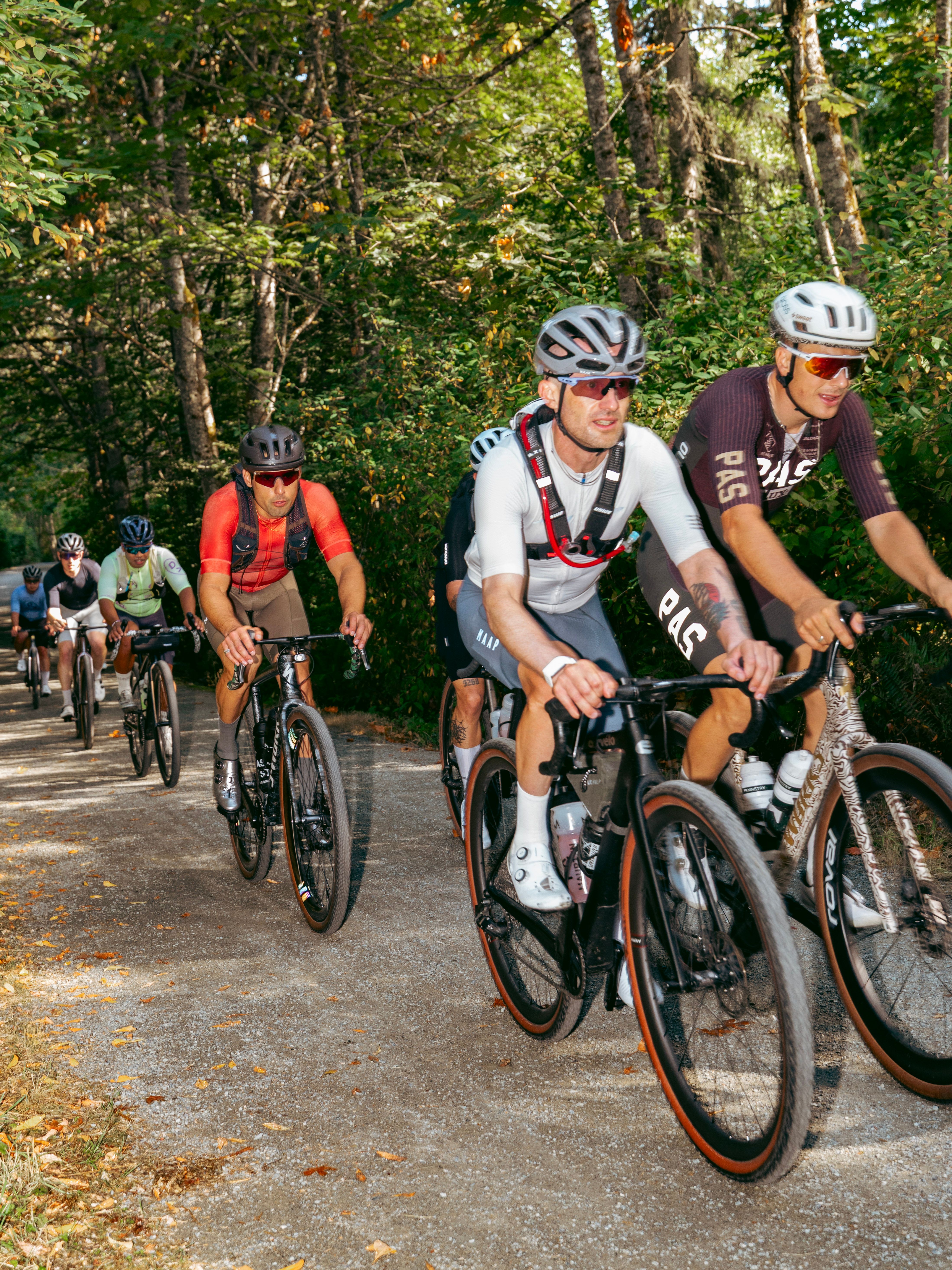 Cyclists on gravel wearing Pas Normal Studios
