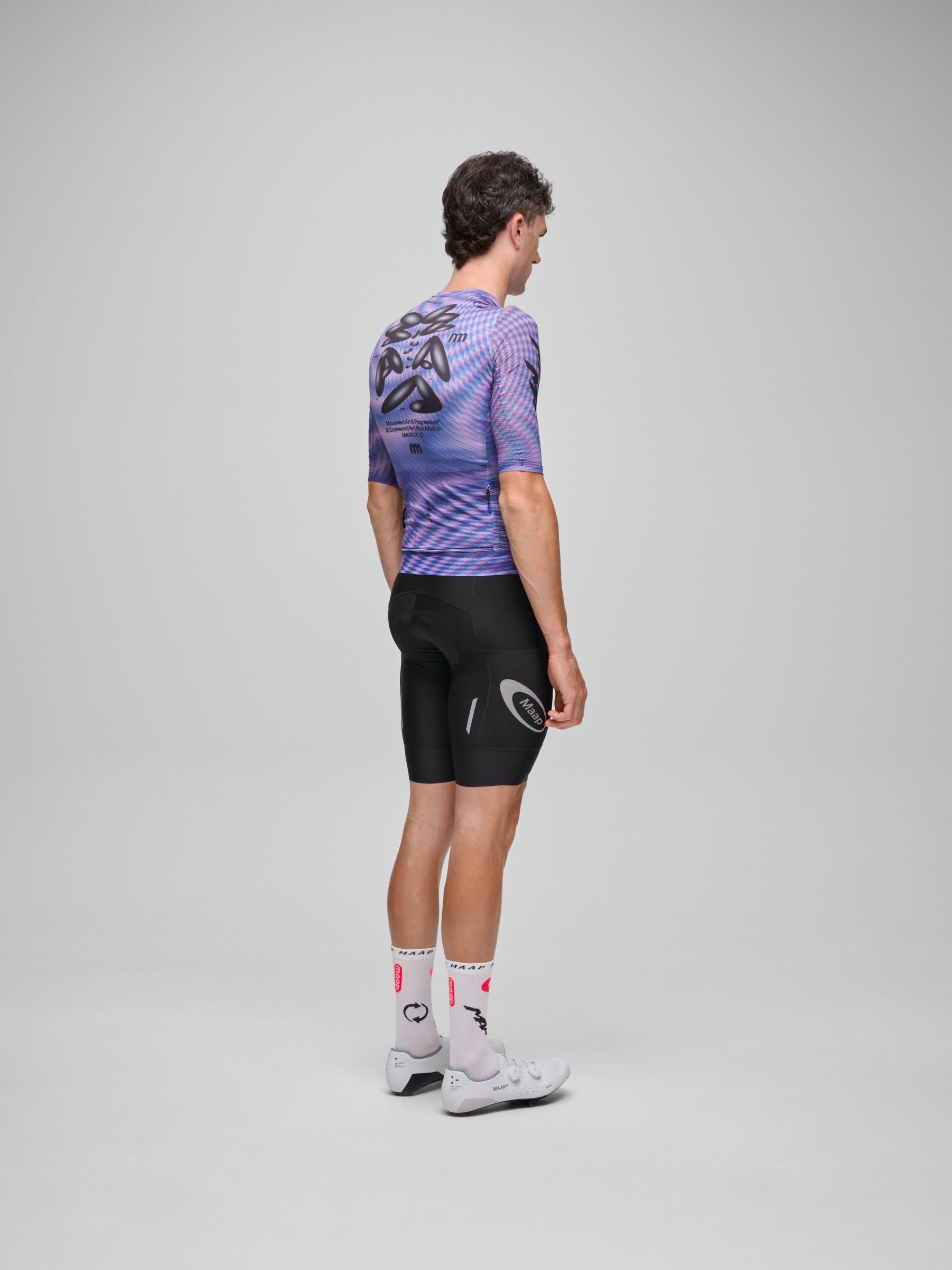MAAP Spectrum Pro Air Jersey 3.0, glitch, on-model rear three-quarter view, dropped hem, close body fit over bib shorts.
