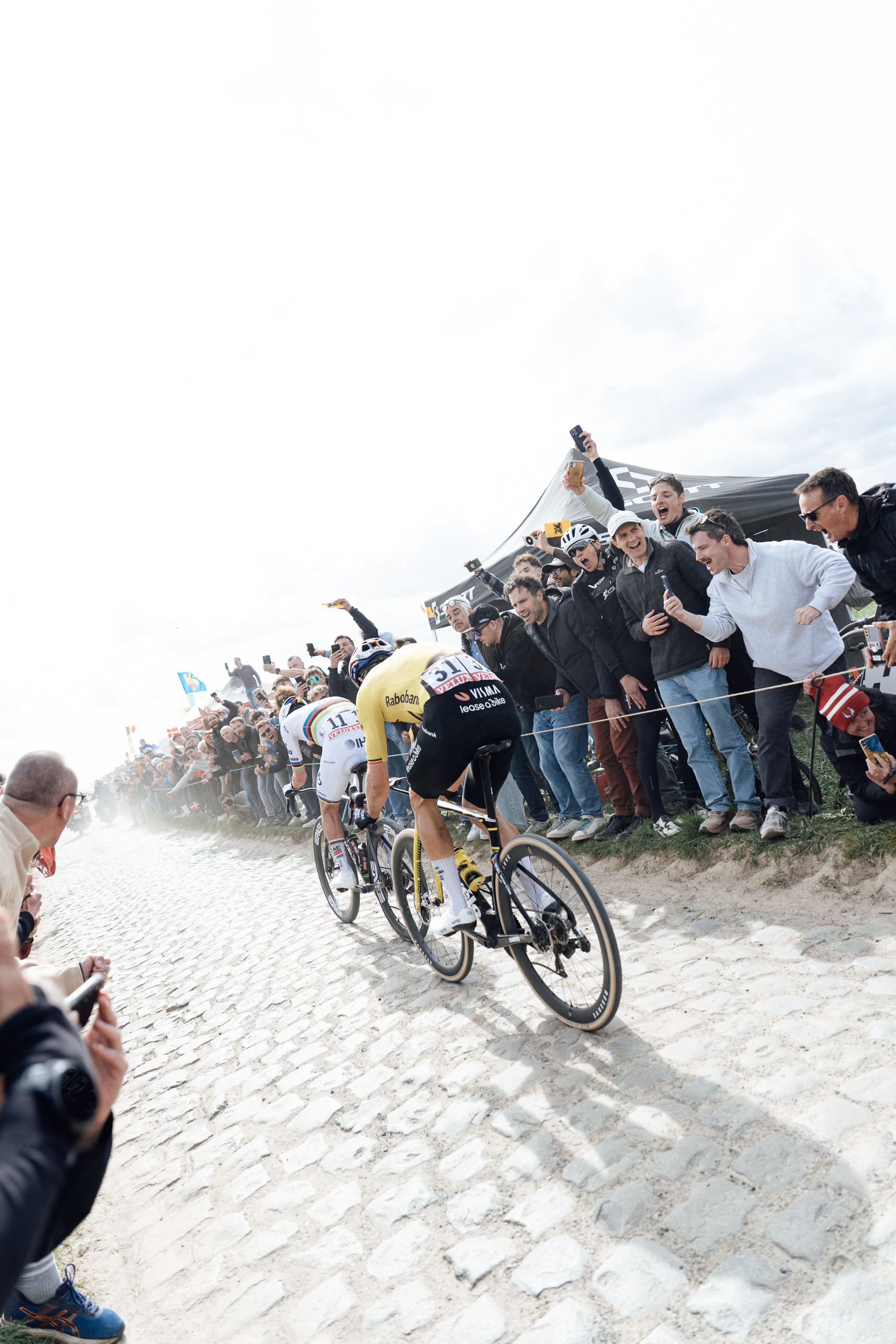 Tadej Pogacar and Wout Van Ert riding the cobbles of Paris Roubaix