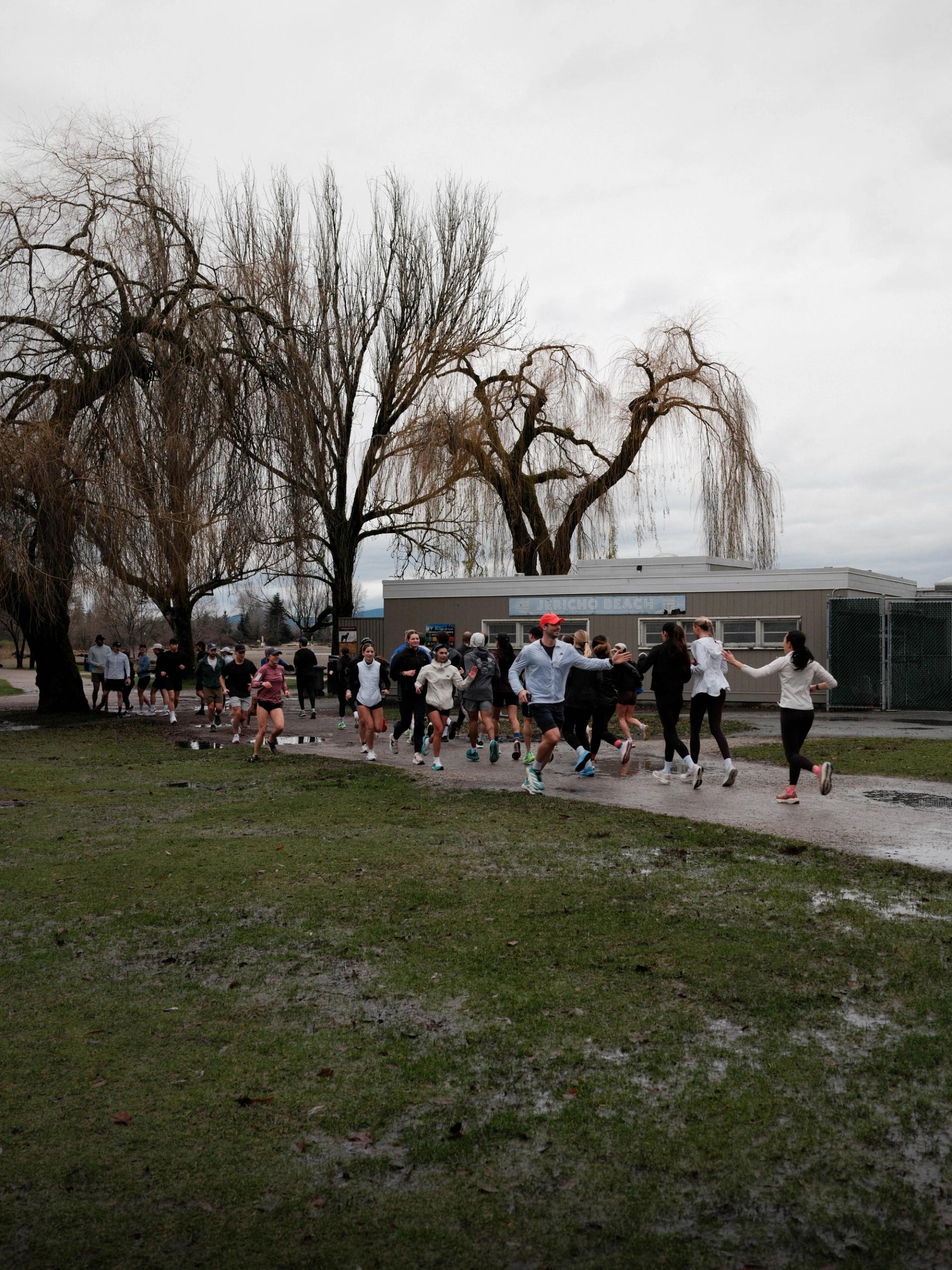Group running in Jericho Vancouver, high fiving