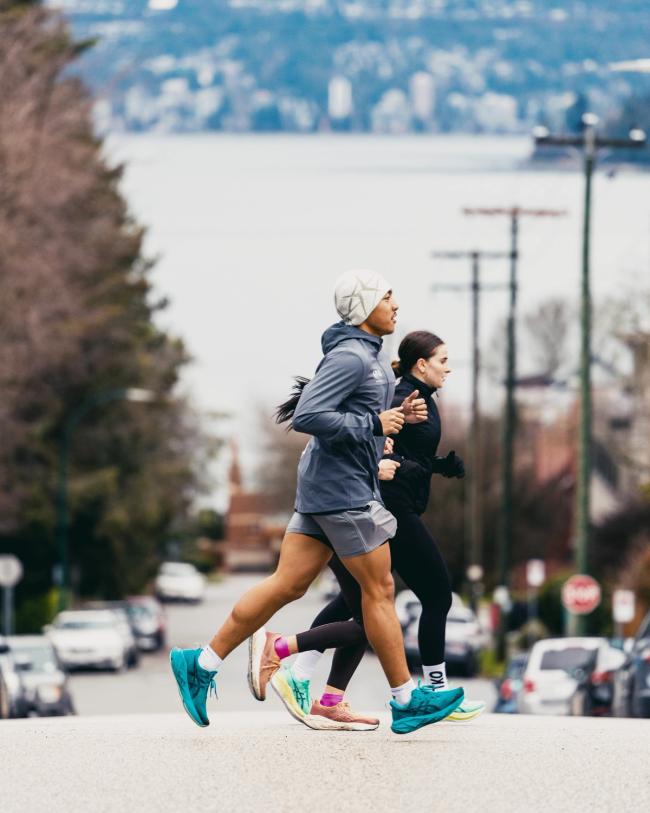 Runners running in front of view of ocean in Vancouver