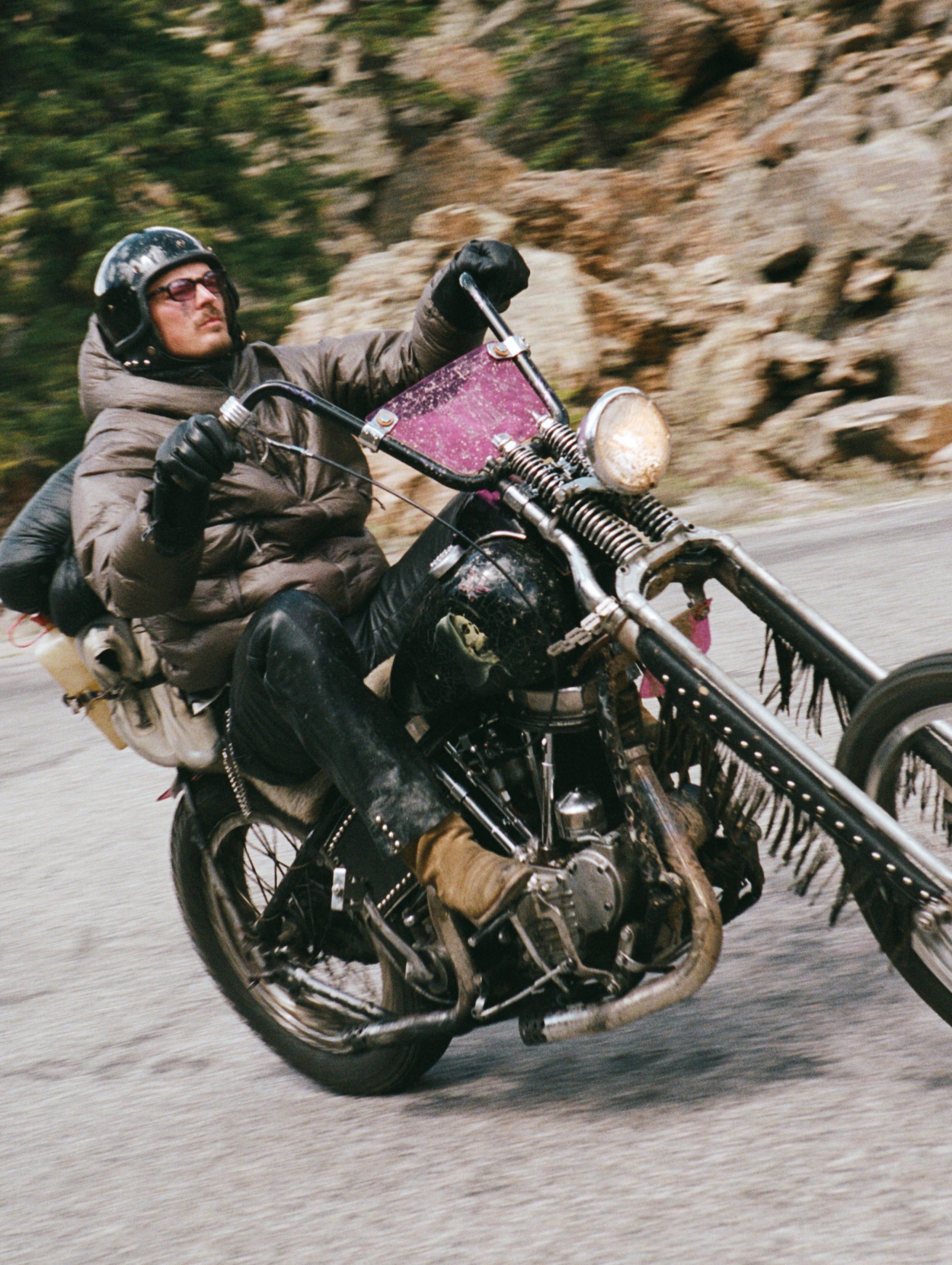 Rider in a Satisfy Rippy Force puffer on a mountain road