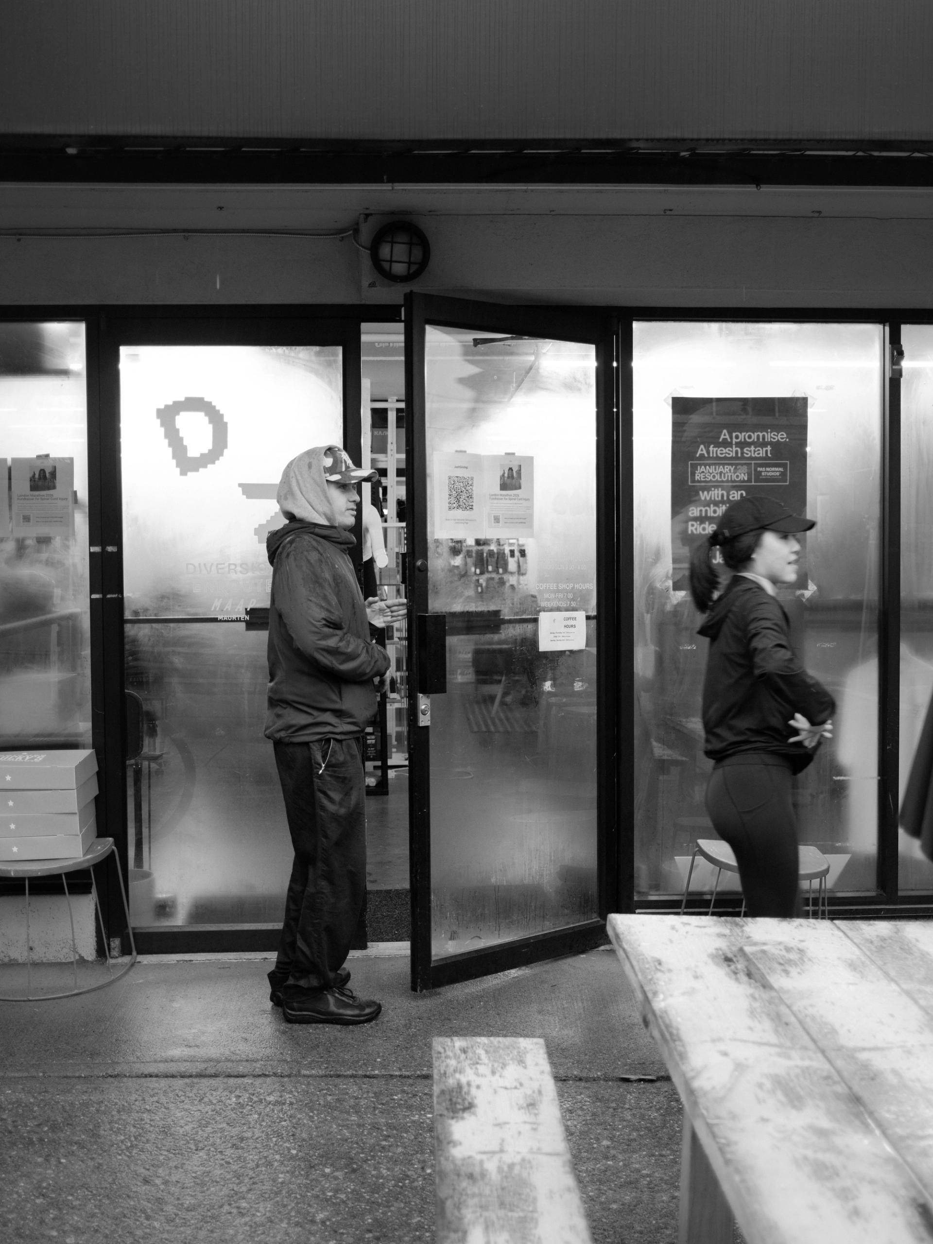 Runner opening door of Enroute.cc Store in Kitsilano