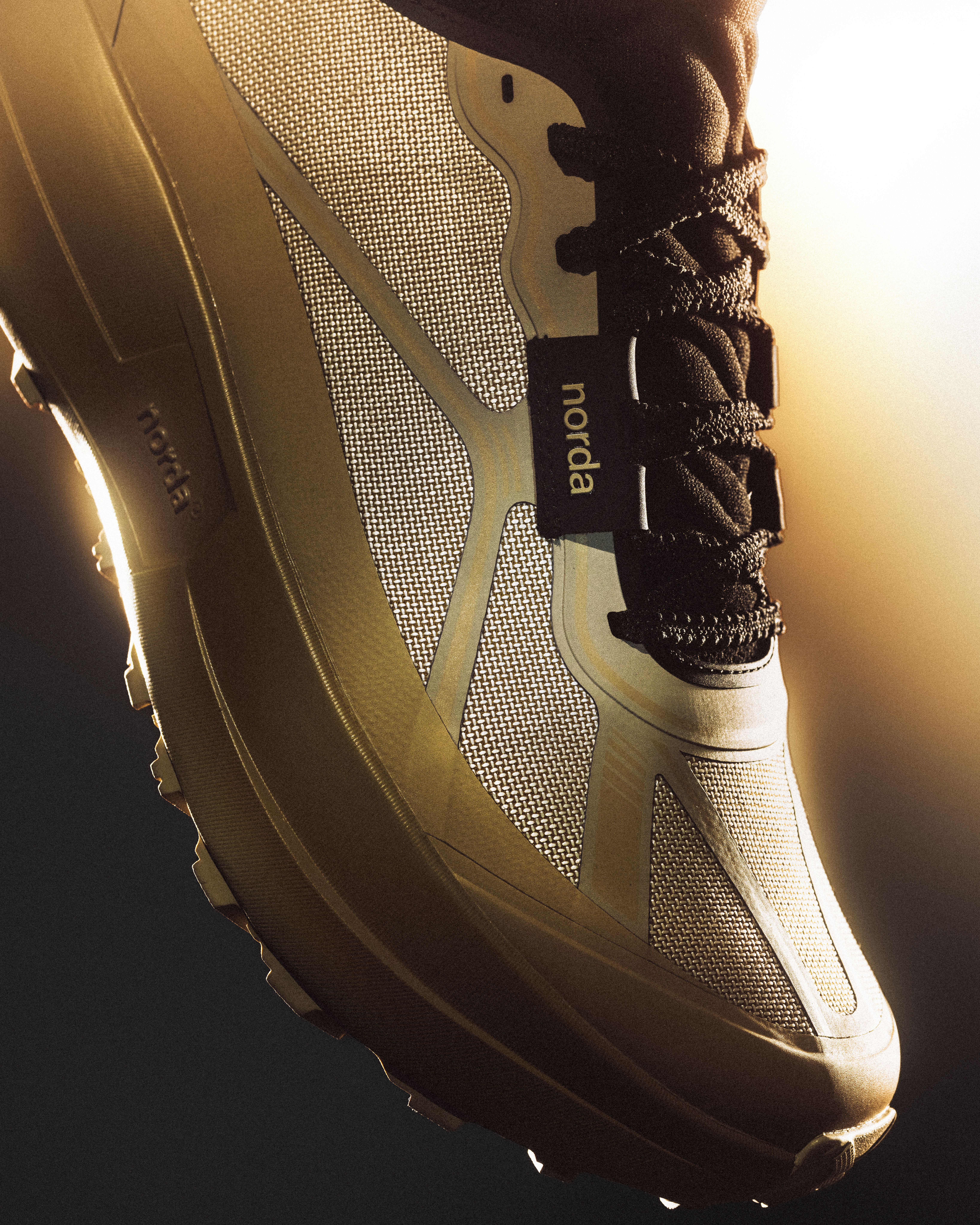 Close-up of the norda 055 bio-circular Dyneema woven upper in warm light