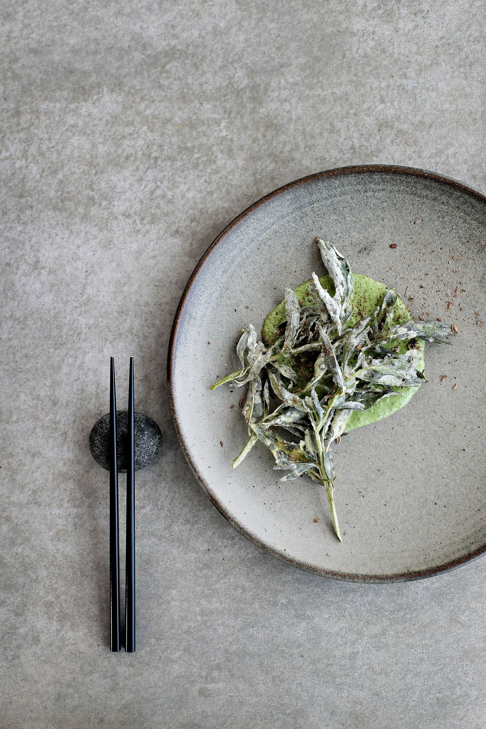 Chopsticks and plate with green leaves