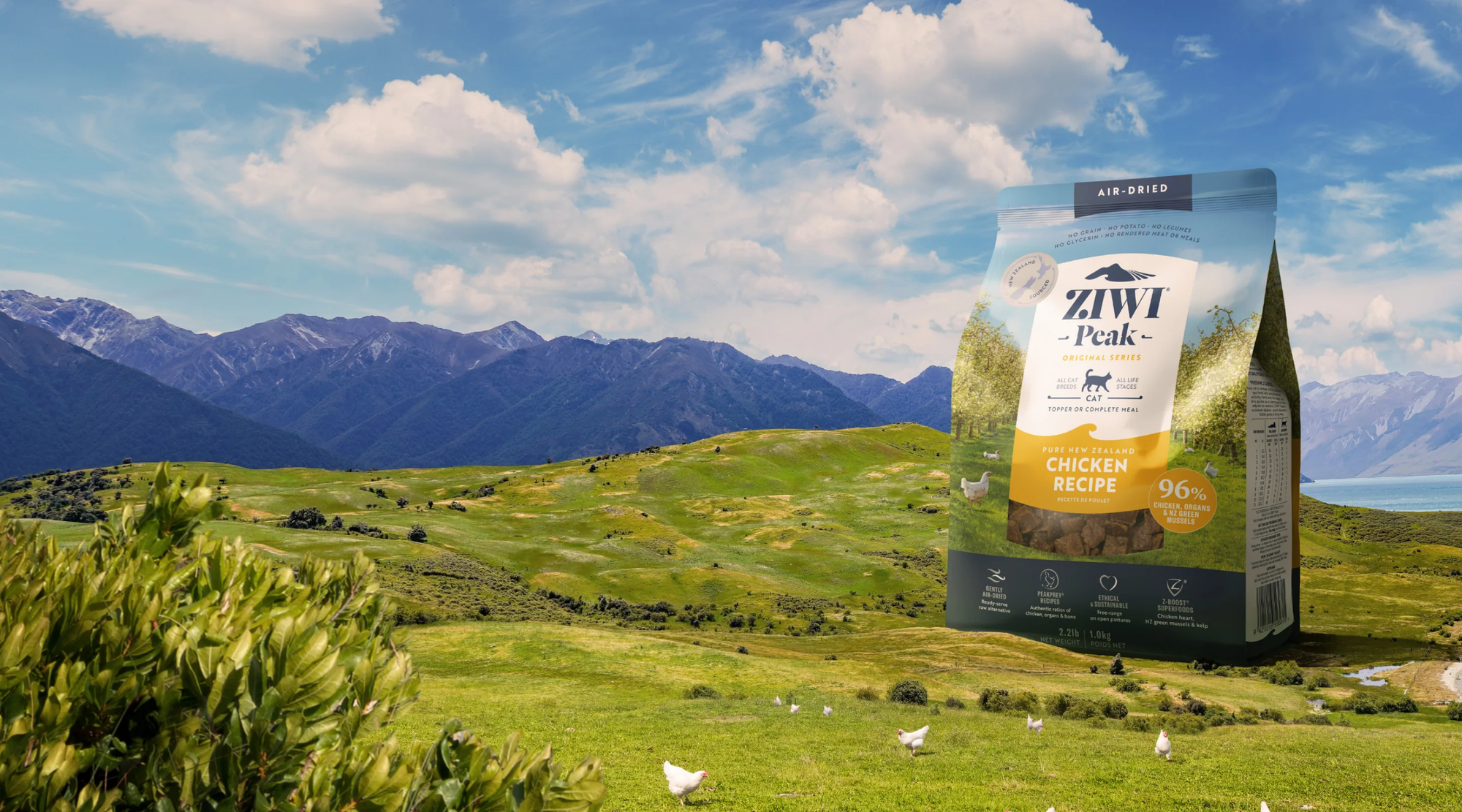 a bag of ziwi peak cat food in a field with mountains in the background a bag of ziwi peak cat food in a field with mountains in the background