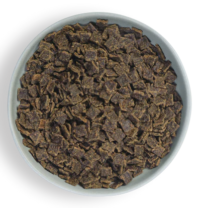 a white bowl filled with brown cereal on a black background