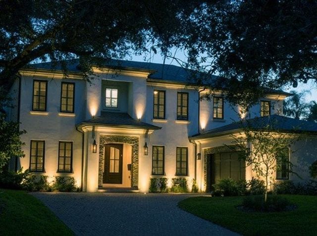 Uplighting washing a white stucco facade