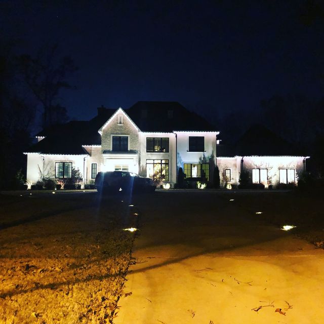 Down lighting washing the perimeter of a large home