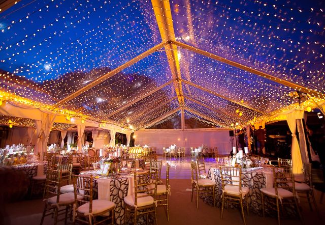A twinkle-light canopy inside a reception tent