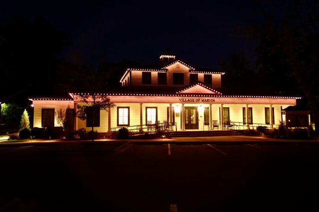 A town hall lit in warm white at night