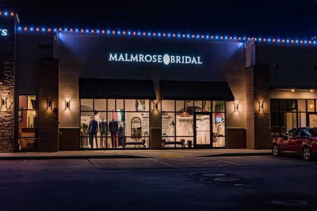 A storefront lit in red, white and blue