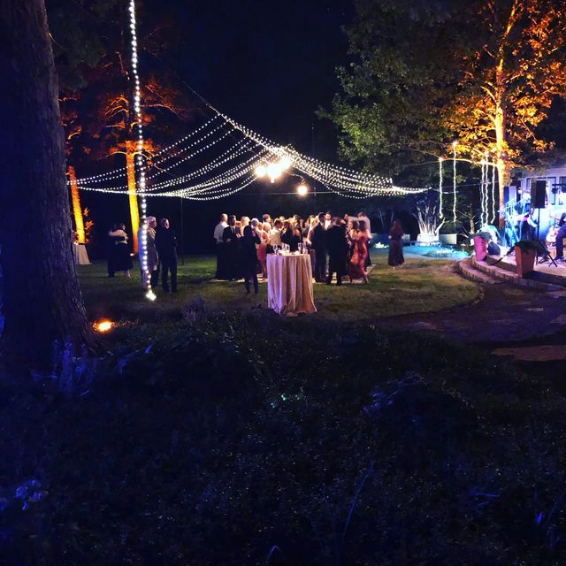 A string-light canopy over an outdoor gathering