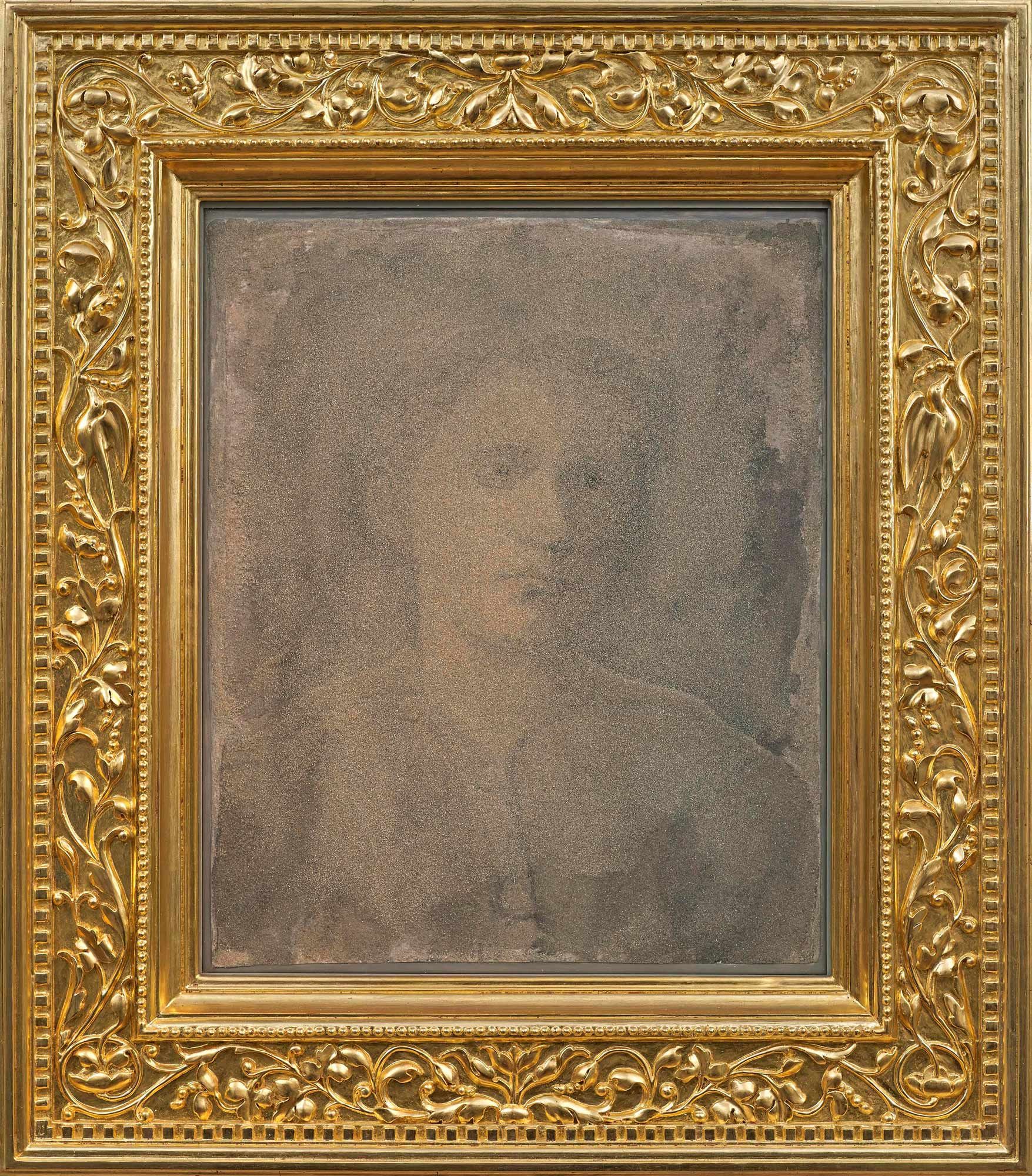 Portrait of young boy made from quartz sand looking sad and alone in gold-leafed frame.