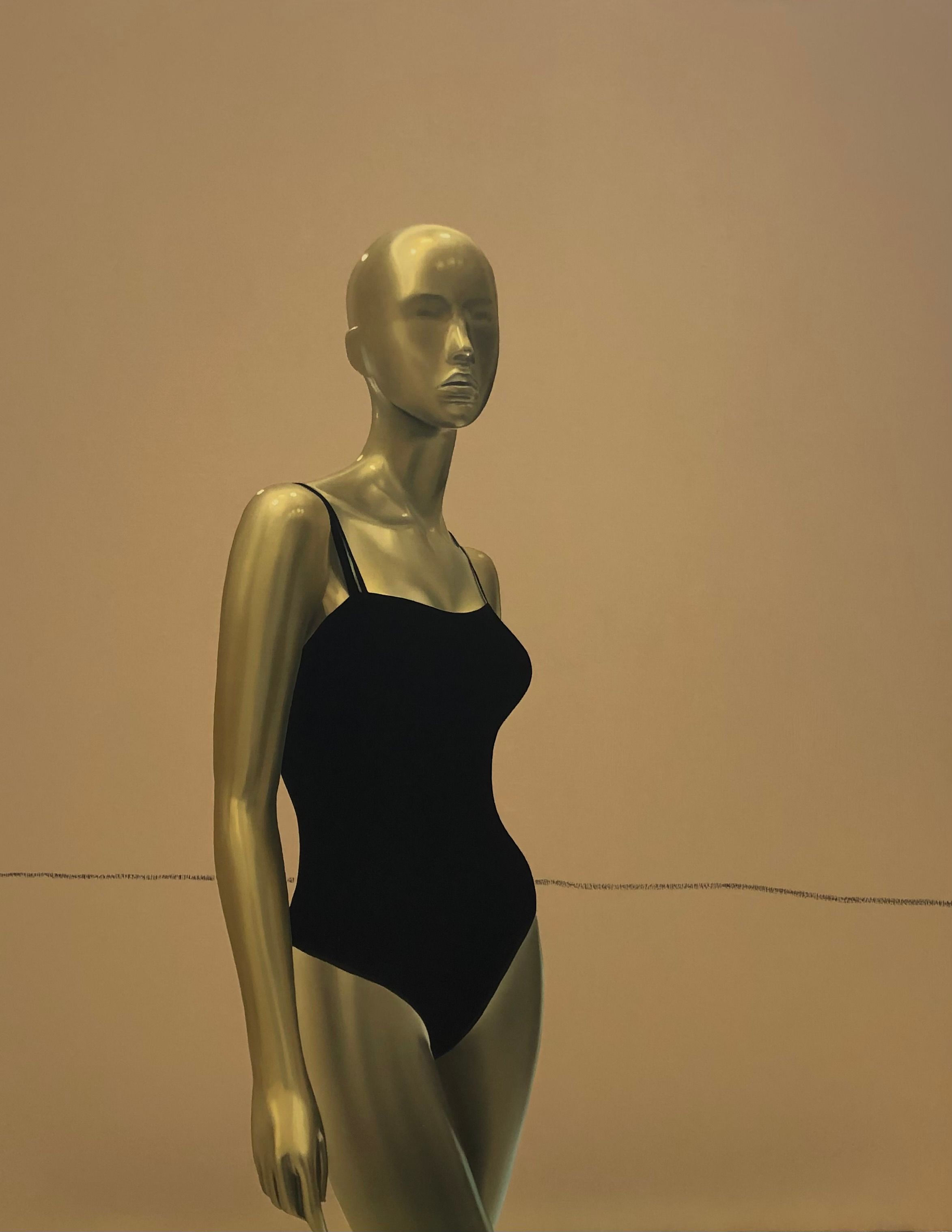 Mannequin in black bathing suit with a minimalistic beige background.