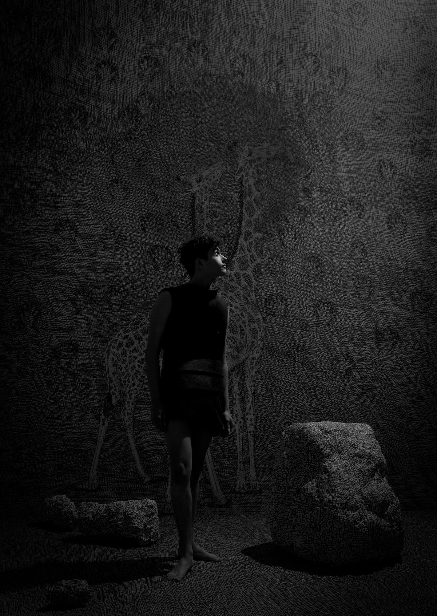 Boy in dark attire stands in a cave, looking up, with wall etchings of giraffes and handprints around.
