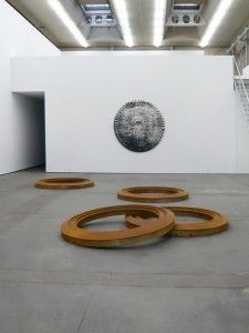 Gallery view of steel rings in front of silkscreen painting.