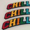 Custom colorful "CHILL" letter chenille patches with dark felt backing for streetwear and hoodies