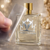 Peeling film off a custom metallic silver crown logo UV DTF transfer label on a luxury perfume bottle