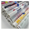 Stacked rolls of custom printed DTF transfer film ready to ship for garment printing