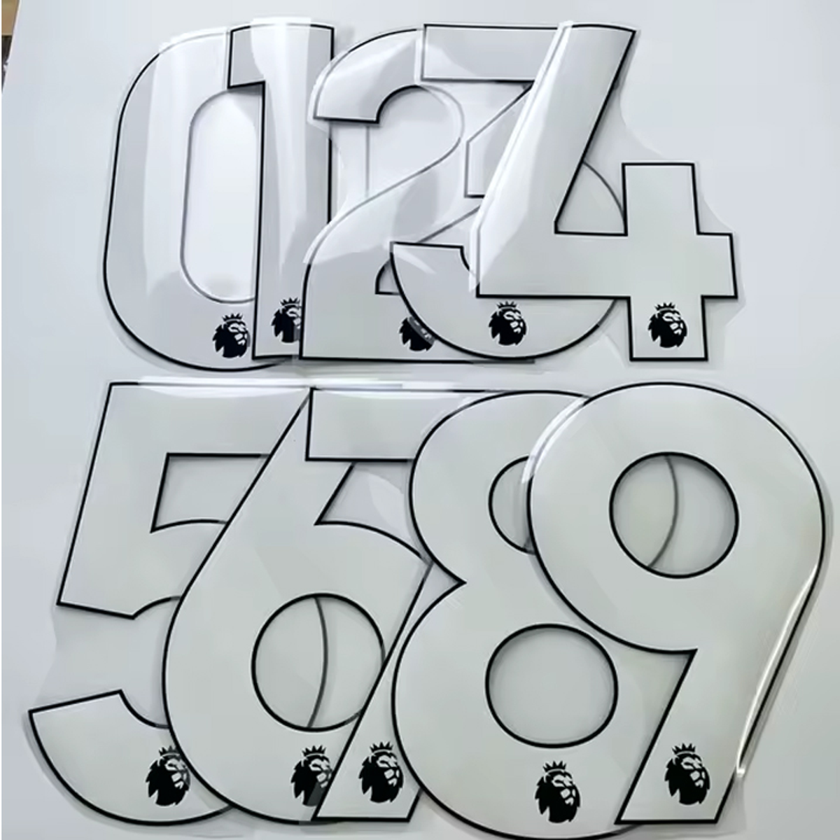 White heat transfer vinyl numbers with league logo for custom football kit printing.